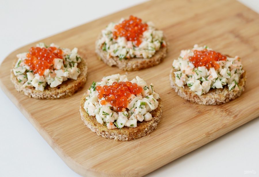 Toasts Skagen with caviar and prawns