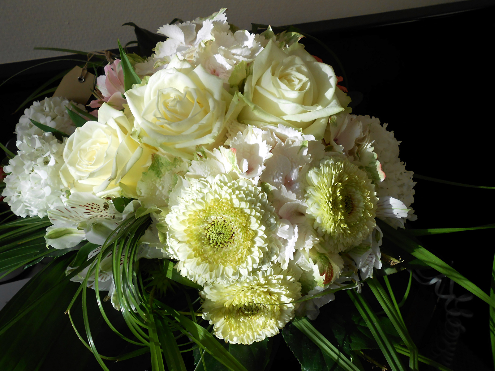 white roses with light yellow dahlias, added sprigs of greenery