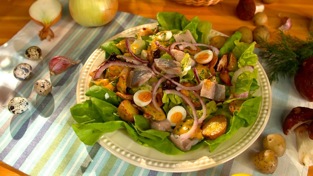 Salad with herring, quail egg and cheese