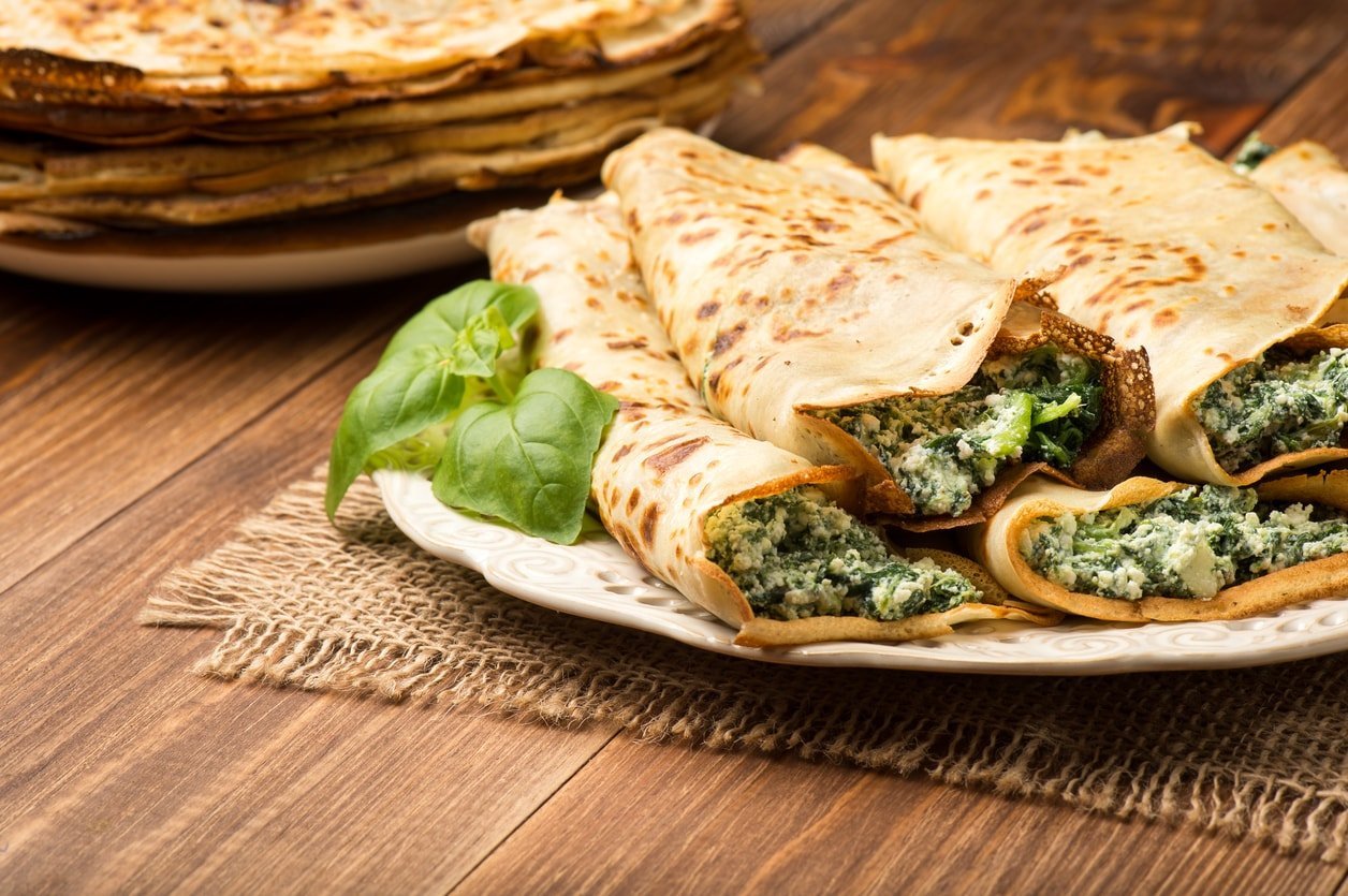 Pancakes with spinach, cheese and pine nuts